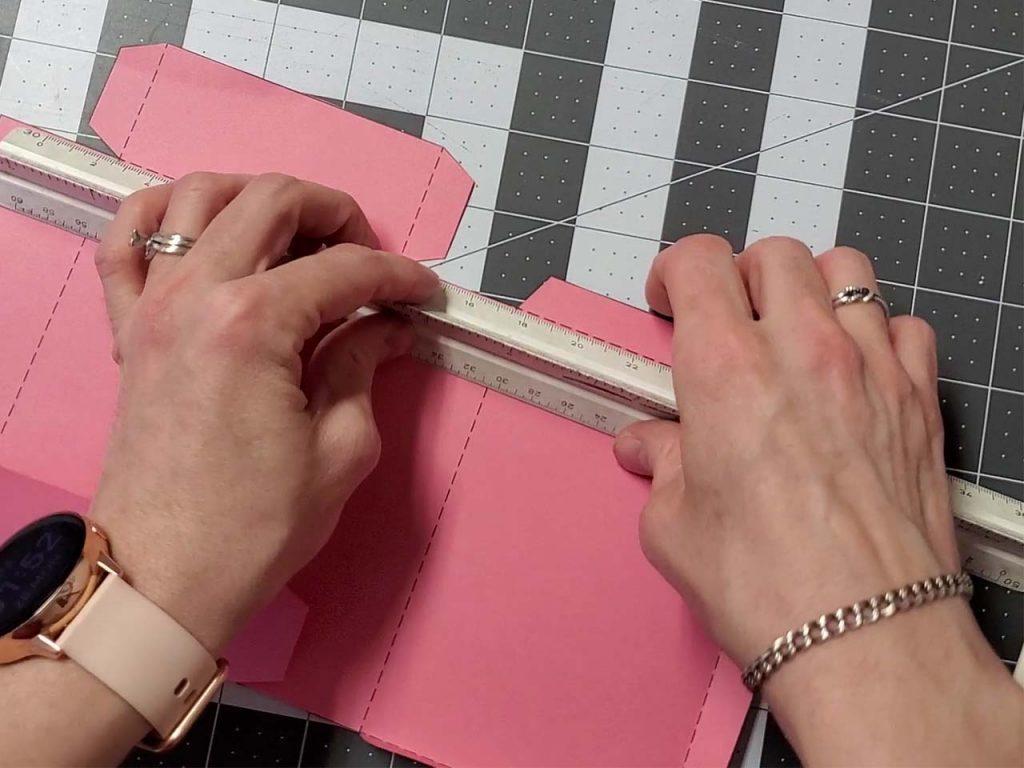 using a ruler to fold tabs along the dotted line